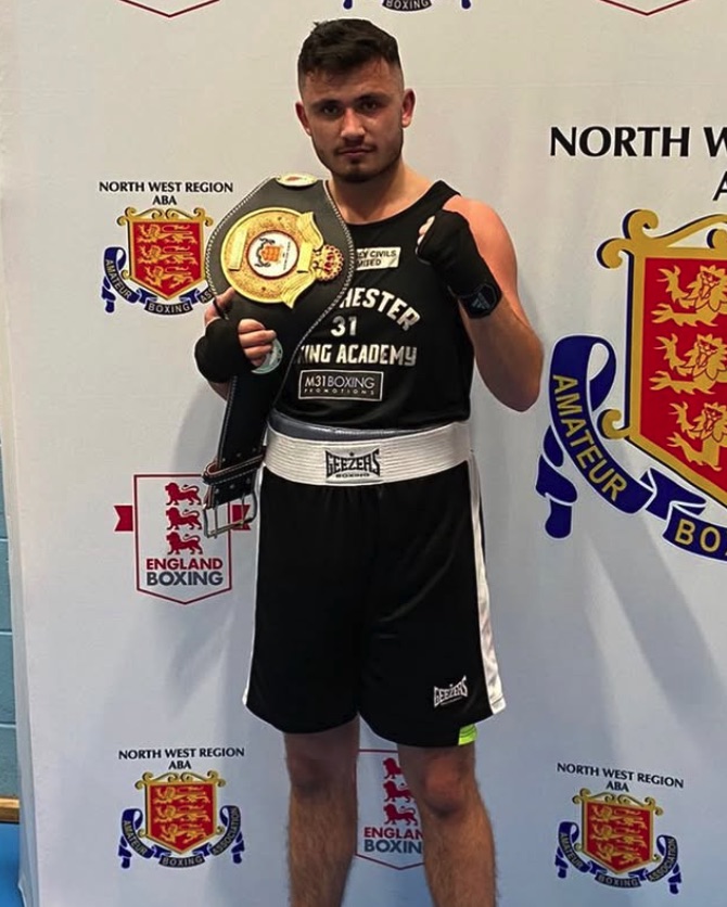 Boxer holding championship belt.