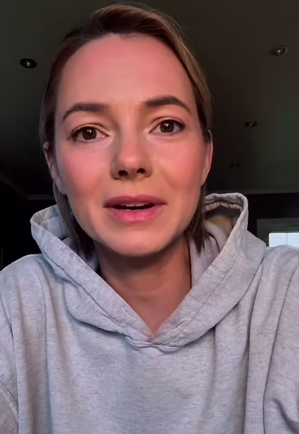 Kara Tointon in a grey hoodie, speaking to the camera.