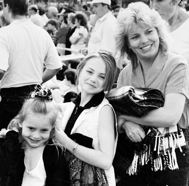 Black and white photo of Kara Tointon with her two young daughters.