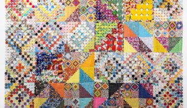 an artwork comprising cloth made from woven and connected pieces of plastic and paper, creating colorful patterns