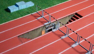 a photograph of a miniature sculpture construction of a running track with stairs leading downward in one of the lanes