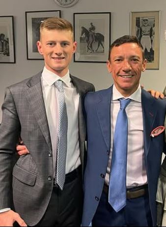 Two men in suits posing for a photo.