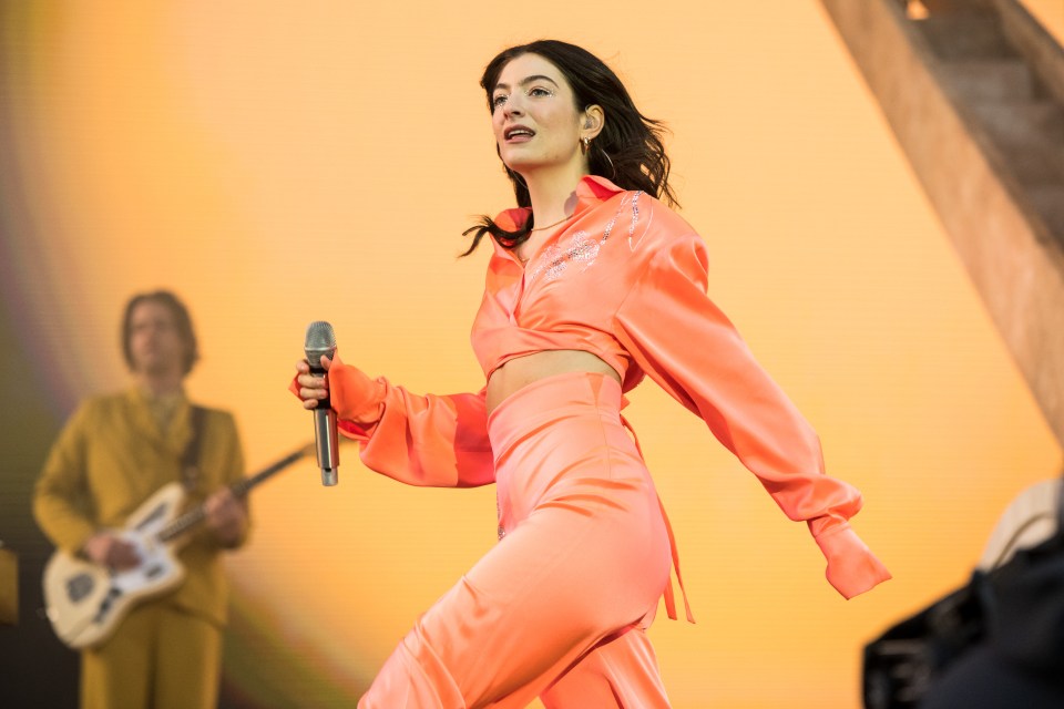 Lorde performing on stage.