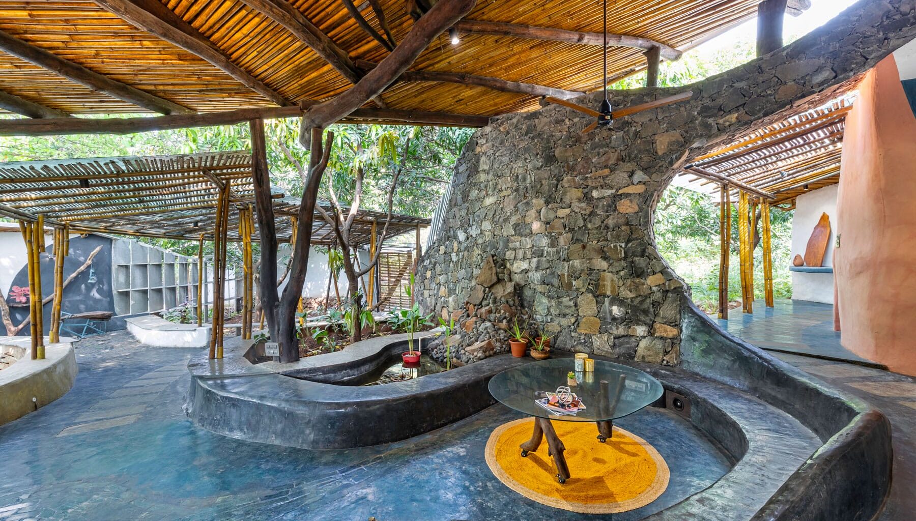 the interior of a biophilic residential design, with wood-beamed ceilings, organic walls, and earthy floors