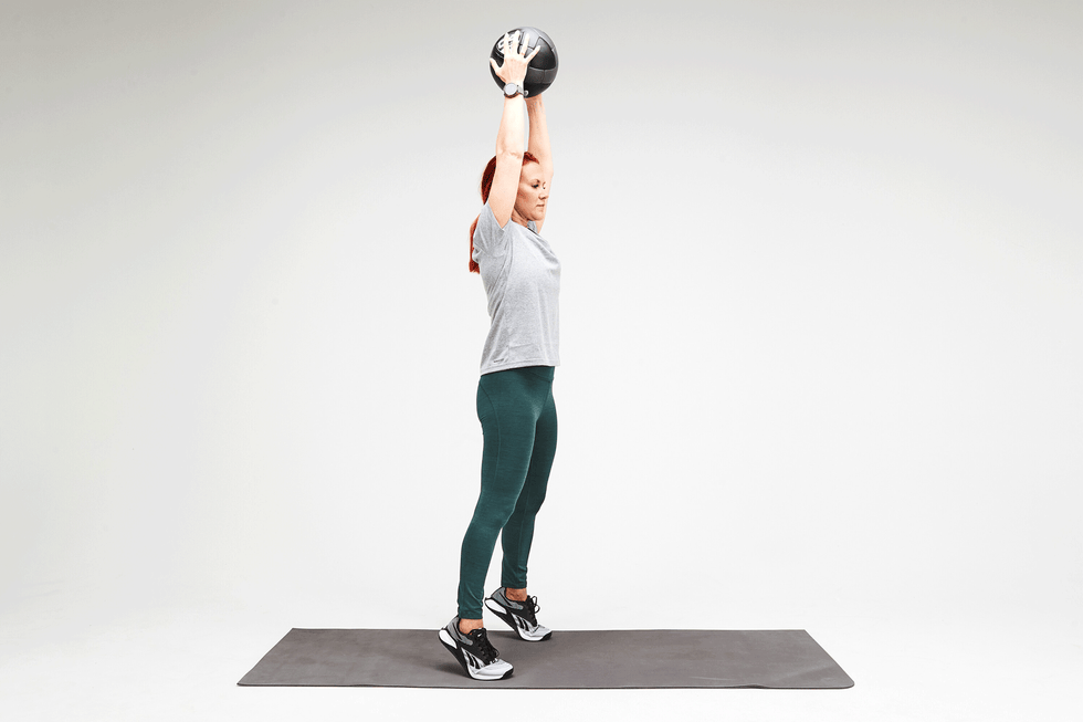person performing a weighted overhead exercise