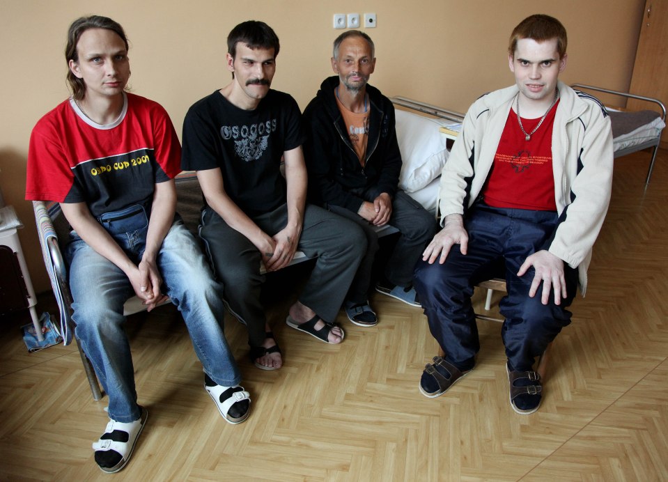 Four surgically castrated sex offenders sitting in a prison cell.