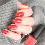 woman wearing a vintage red nail polish, like OPI Nail Lacquer in I'm Not Really A Waitress