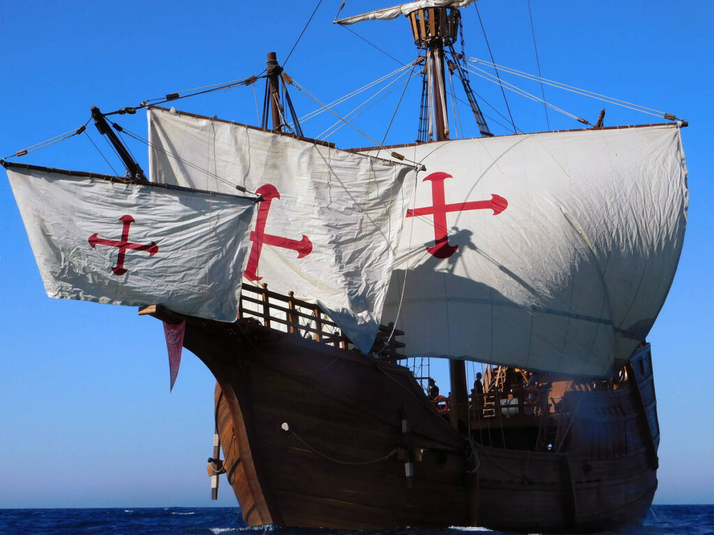 a replica of the christopher columbus ship the nao santa maria, as seen with its sails billowing while sailing across the sea