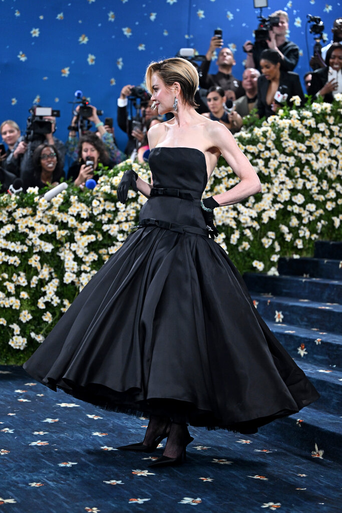 Nicole Kidman is wearing a black strapless dress.