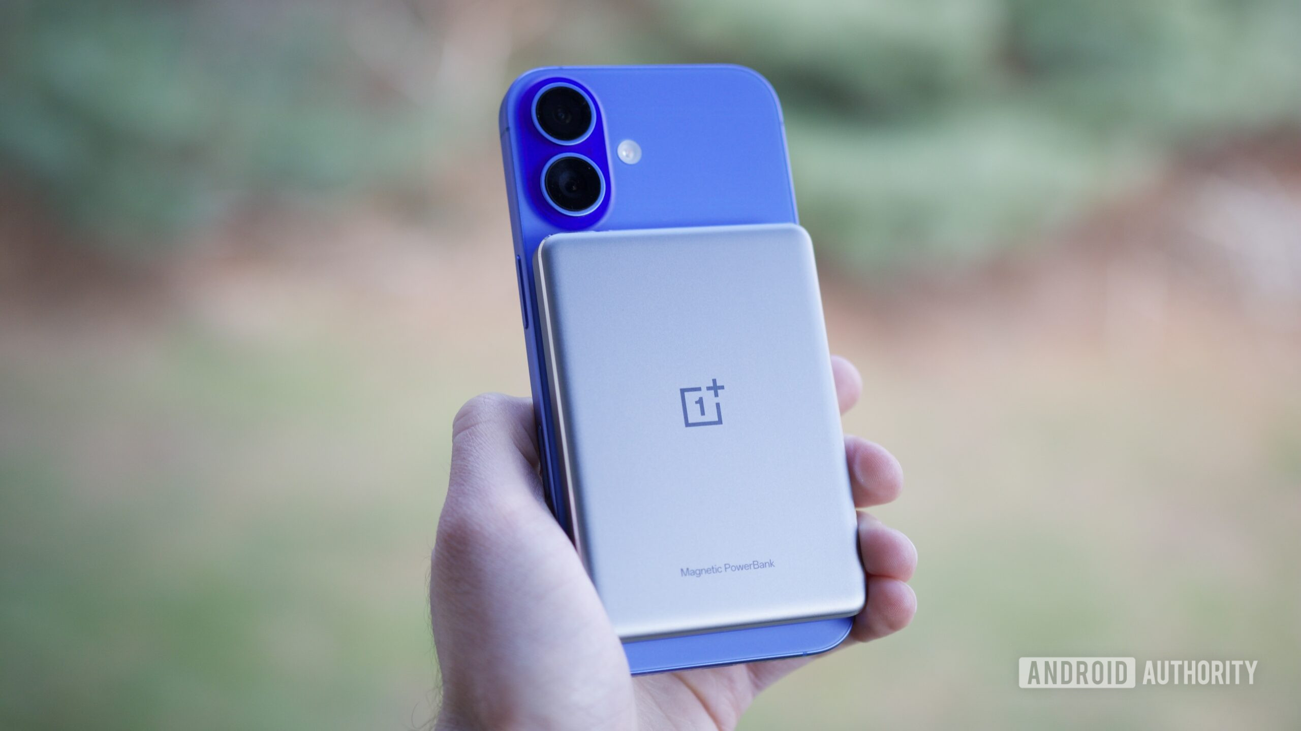 The OnePlus Slim Magnetic Power Bank on an iPhone 16.