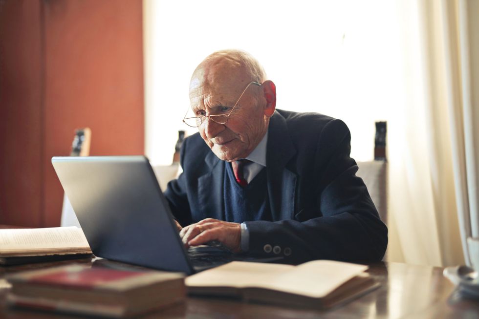 Pensioner looks at laptop