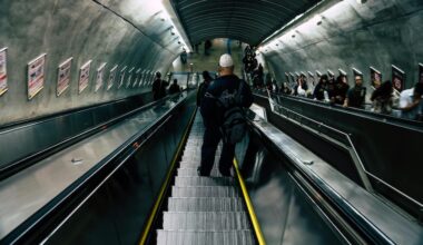Image of commuters travelling down a TfL escalator. (Picture credit: Kaique Rocha)