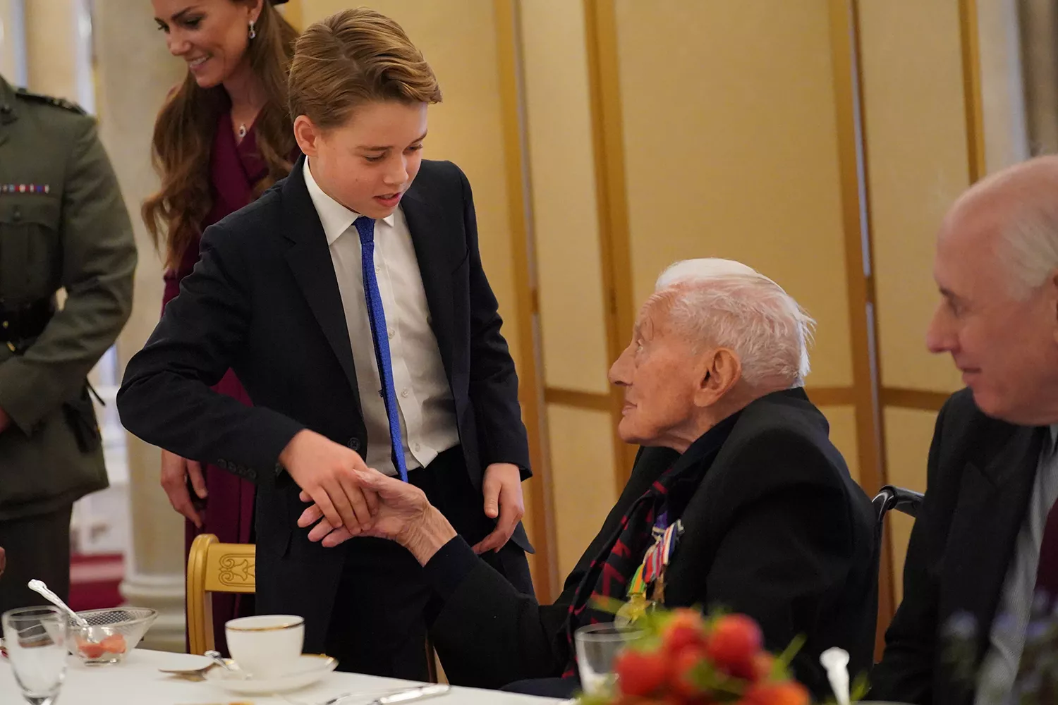 Prince George and Catherine, Princess of Wales speak with Second World War veterans at a tea party in Buckingham Palace on May 5, 2025 in London