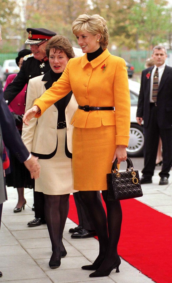 Princess Diana arriving at Liverpool Women's Hospital in a yellow suit and Dior handbag.