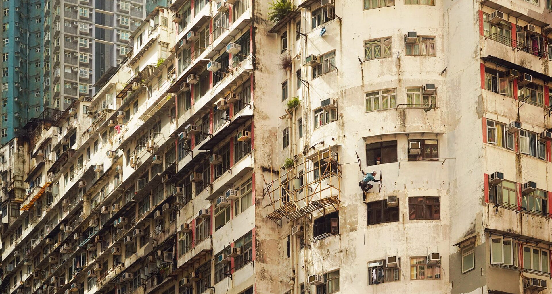 a detail image of a person hanging from the side of a building