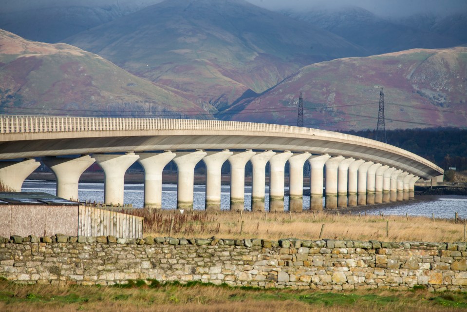 Clackmannanshire Bridge over water with mountains in the background.