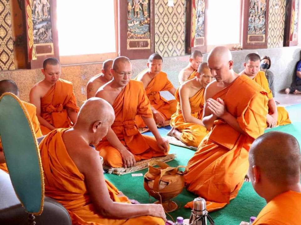 Buddhist monks seated in prayer.