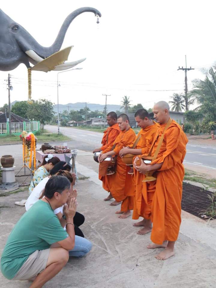 People offering alms to Buddhist monks.