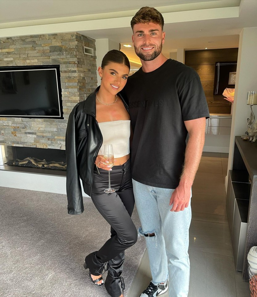Couple posing in a modern home.