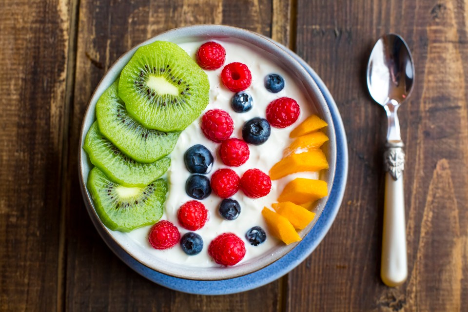 Yogurt bowl with kiwi, raspberries, blueberries, and mango.