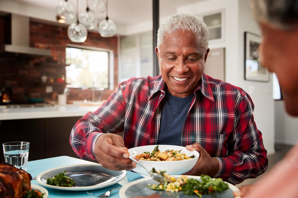 Smiling senior couple enjoying a meal together at home.