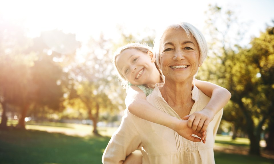 Shot of a little girl and her grandmother enjoying a piggyback ride at the park