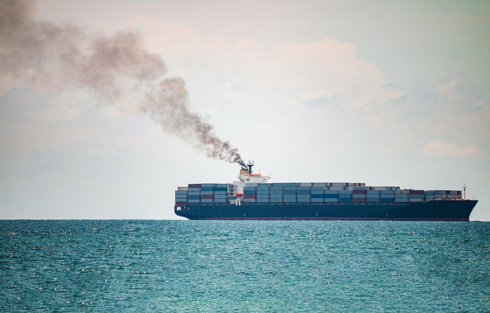 smoke pollution coming from a container ship