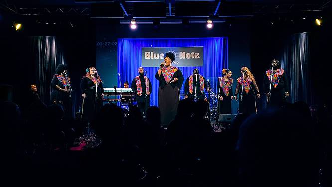 People onstage singing at the Blue Note Jazz Club in Milan