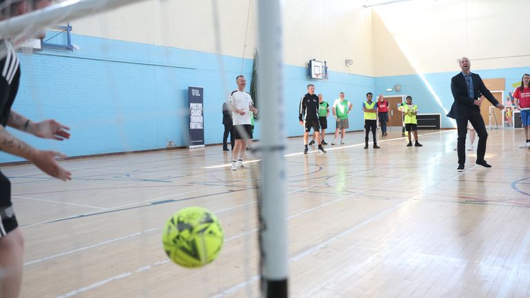 The Prince of Wales playing football during the visit to Leith.
Pic: PA