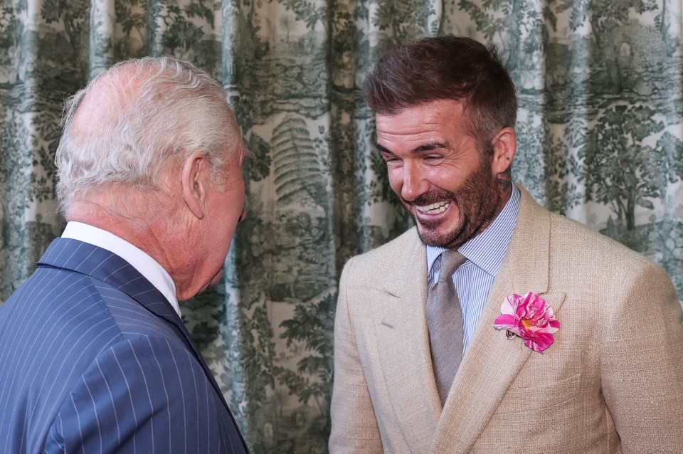 King Charles III speaking with David Beckham.
