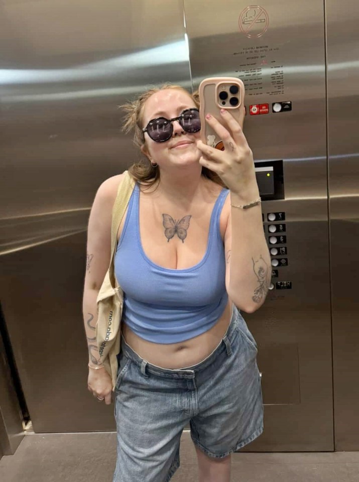 Woman taking a selfie in an elevator.