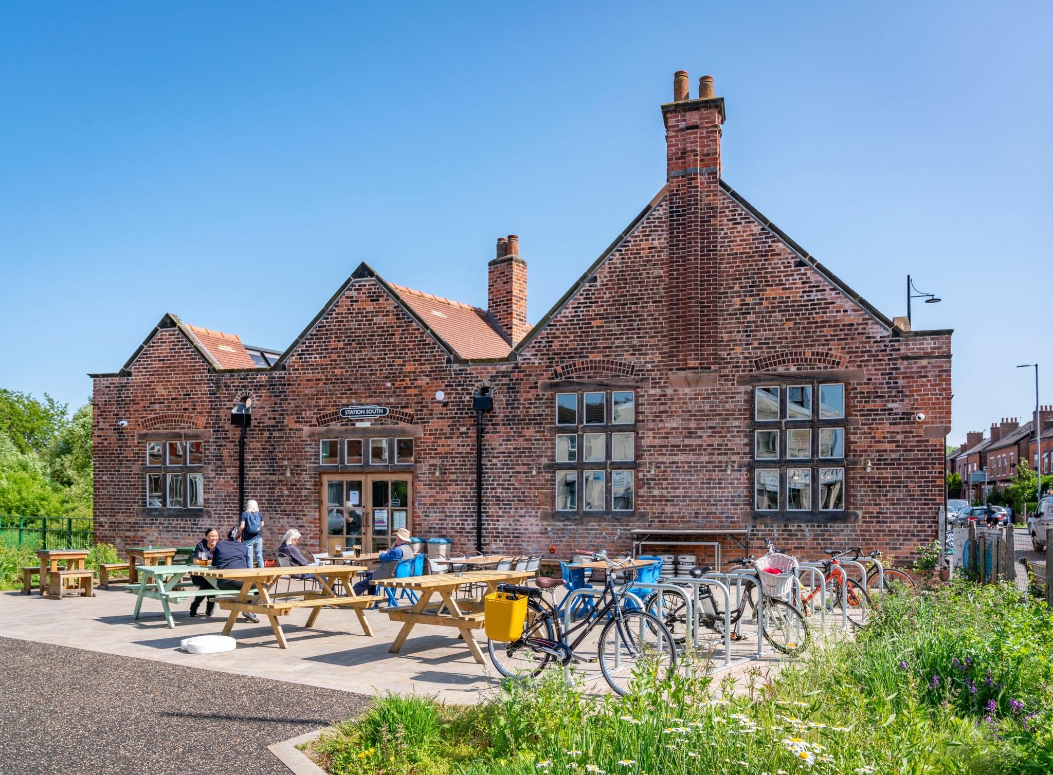 station-south-levenshulme-front-sunny-bikes-garden