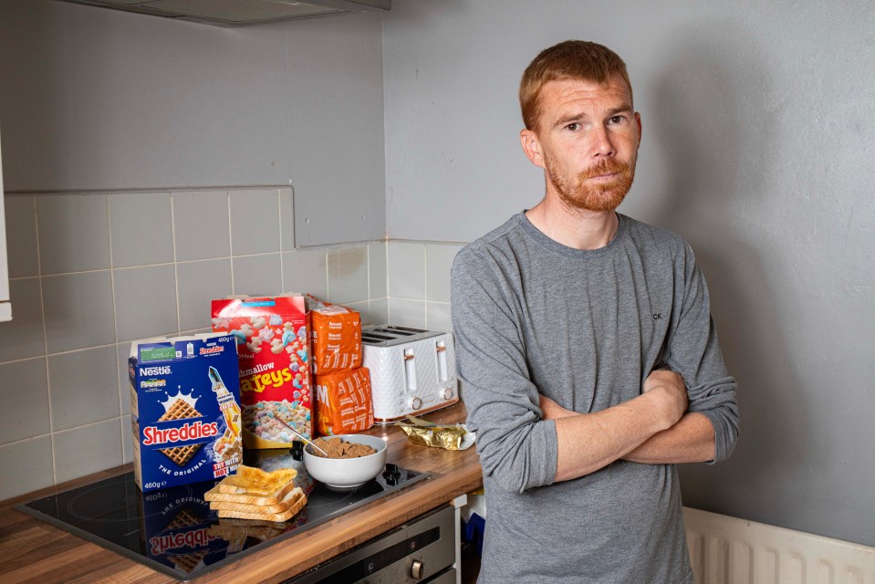A man with ARFID stands in his kitchen with bread and cereal.