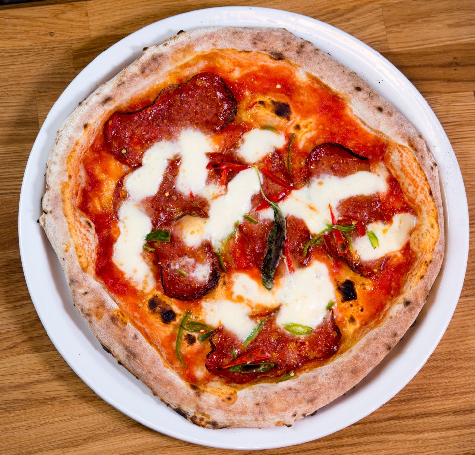 Salami pizza with green chili peppers and mozzarella.
