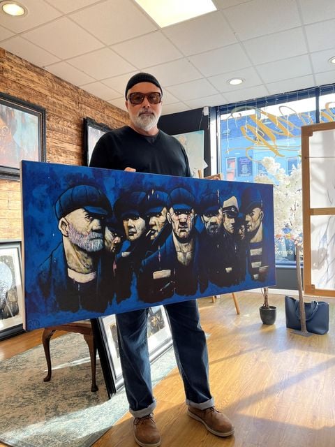 Terry Bradley with his revised Docker's Rest painting as it appears in the film Belfast