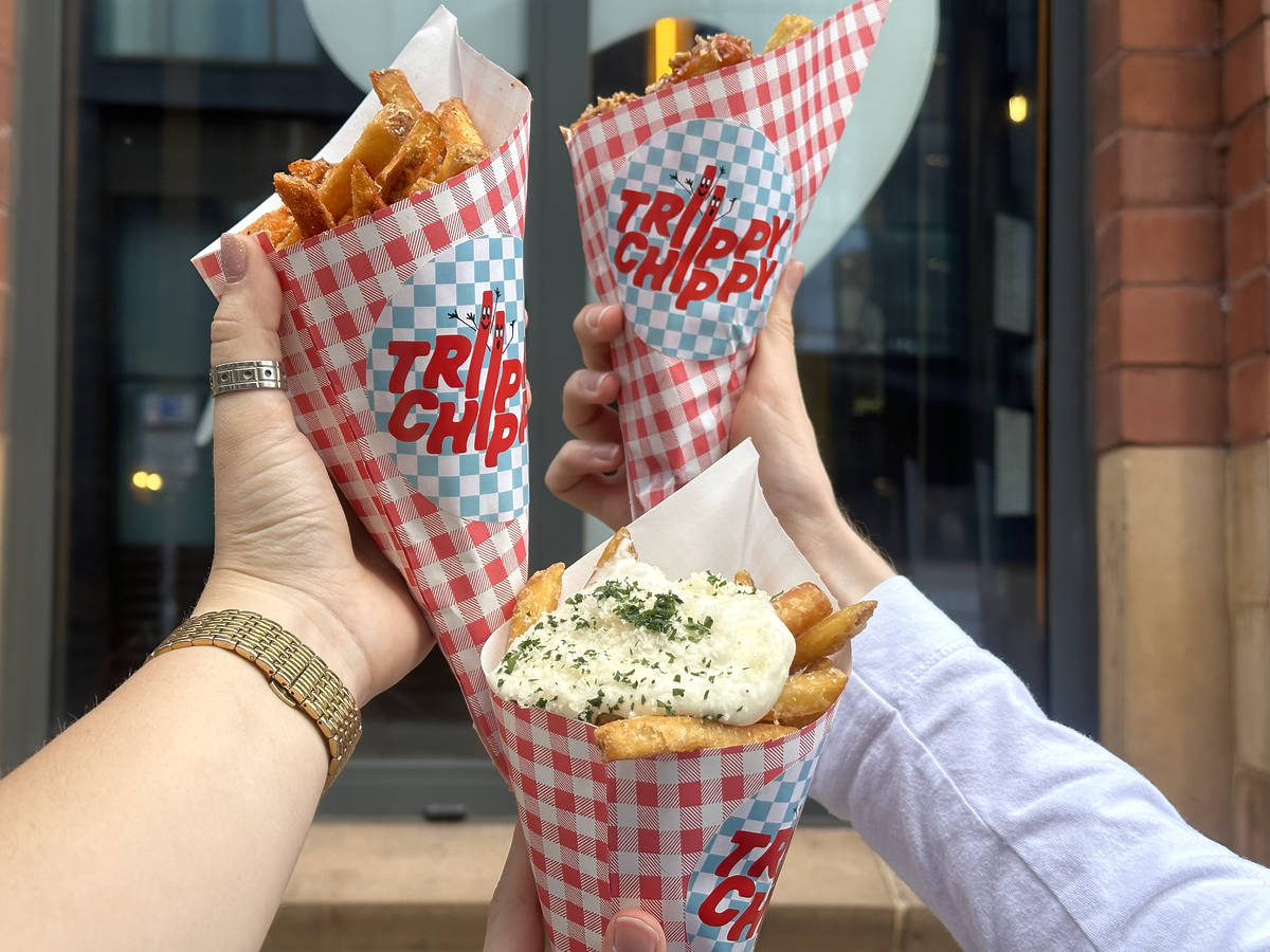 three chip cones with various toppings in hands