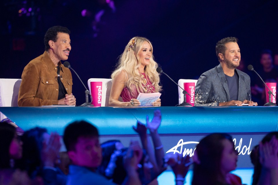 American Idol judges Lionel Richie, Katy Perry, and Luke Bryan at the judges' table.