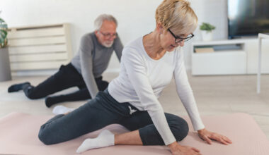 Woman and man stretching hips at home