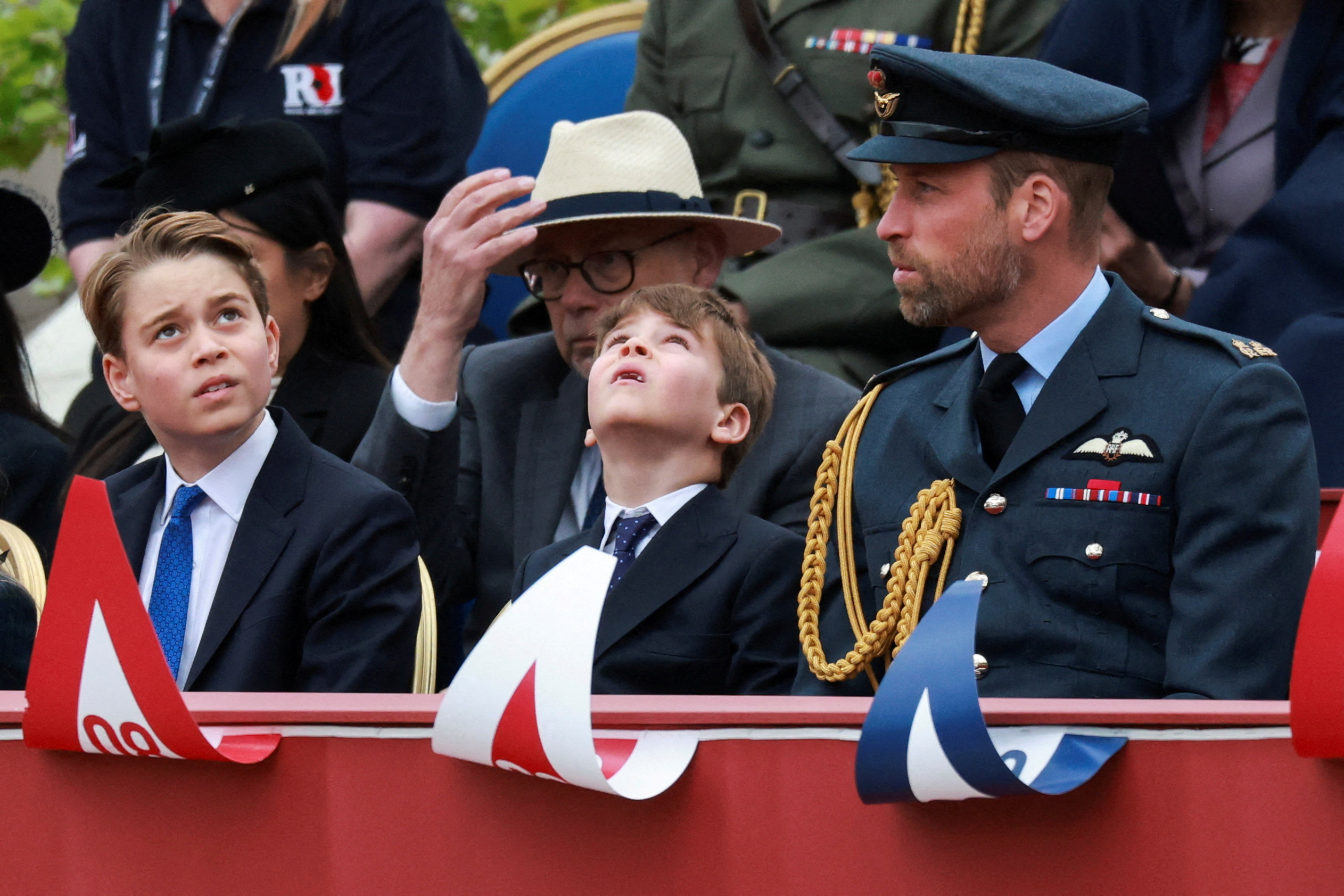 Prince George, Prince Louis, and Prince William watch the parade.