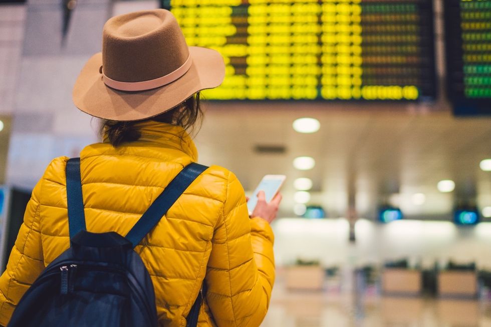 Woman with a backpac at an airport or train station