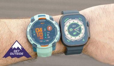 Close-up of the Apple Watch Ultra 2 (left) next to the Garmin Instinct 3 (right) on a user's wrist