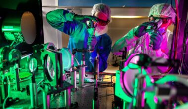 Engineers check optical alignments where the laser pulses are amplified.
