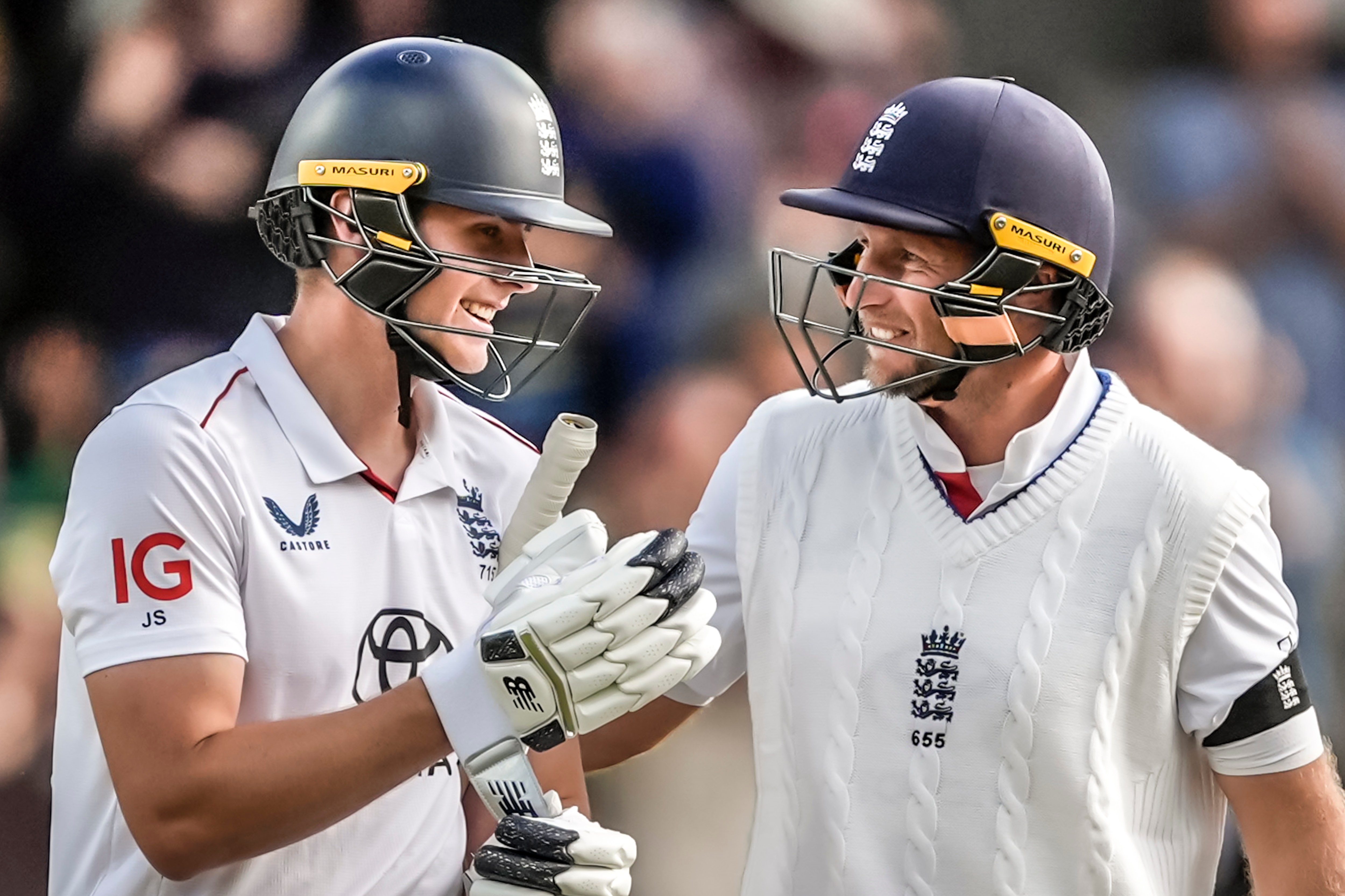 Joe Root and Jamie Smith celebrating a cricket victory.