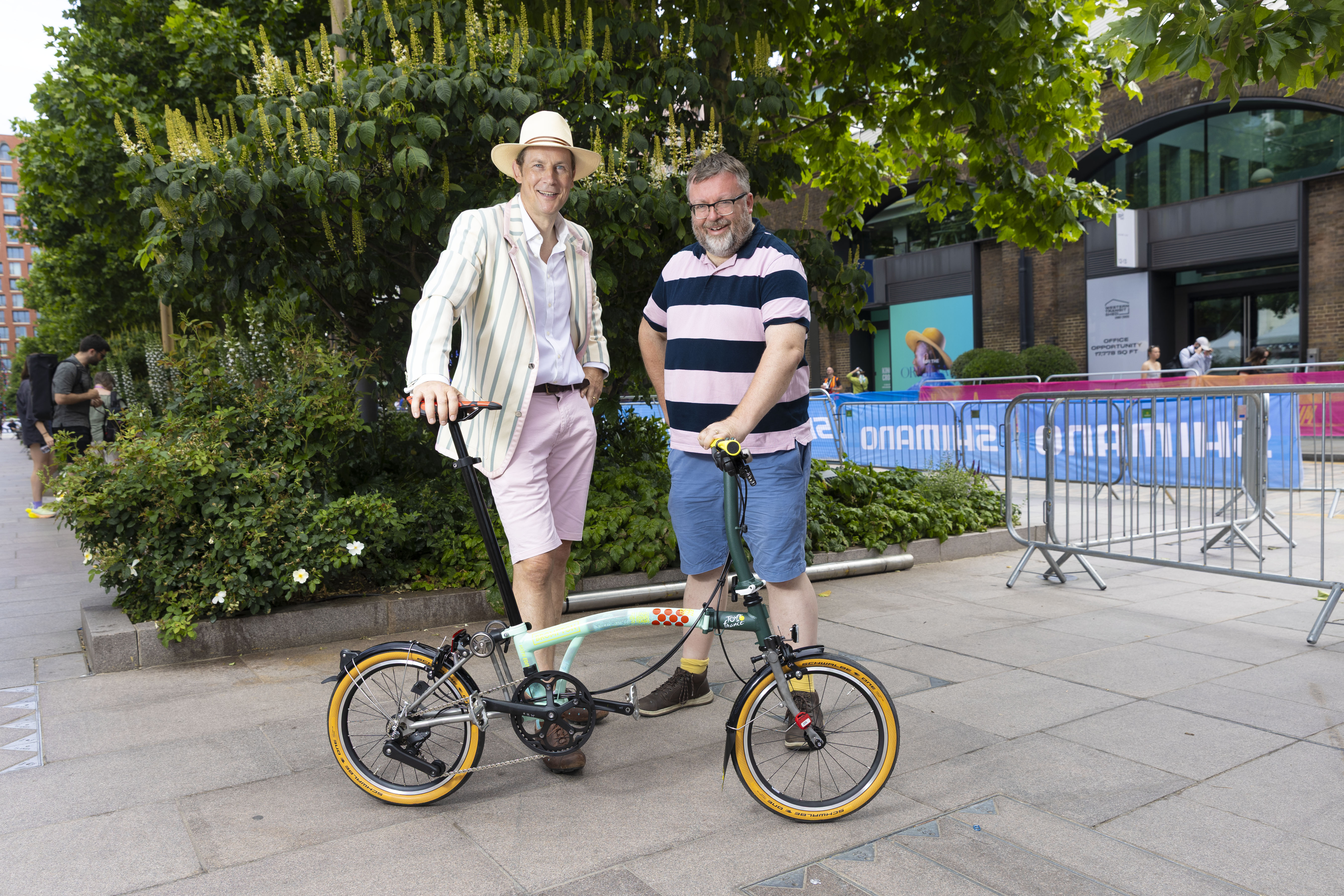 Portrait of Will Butler-Adams, Brompton CEO, and journalist Patrick Kidd with a Brompton bicycle.