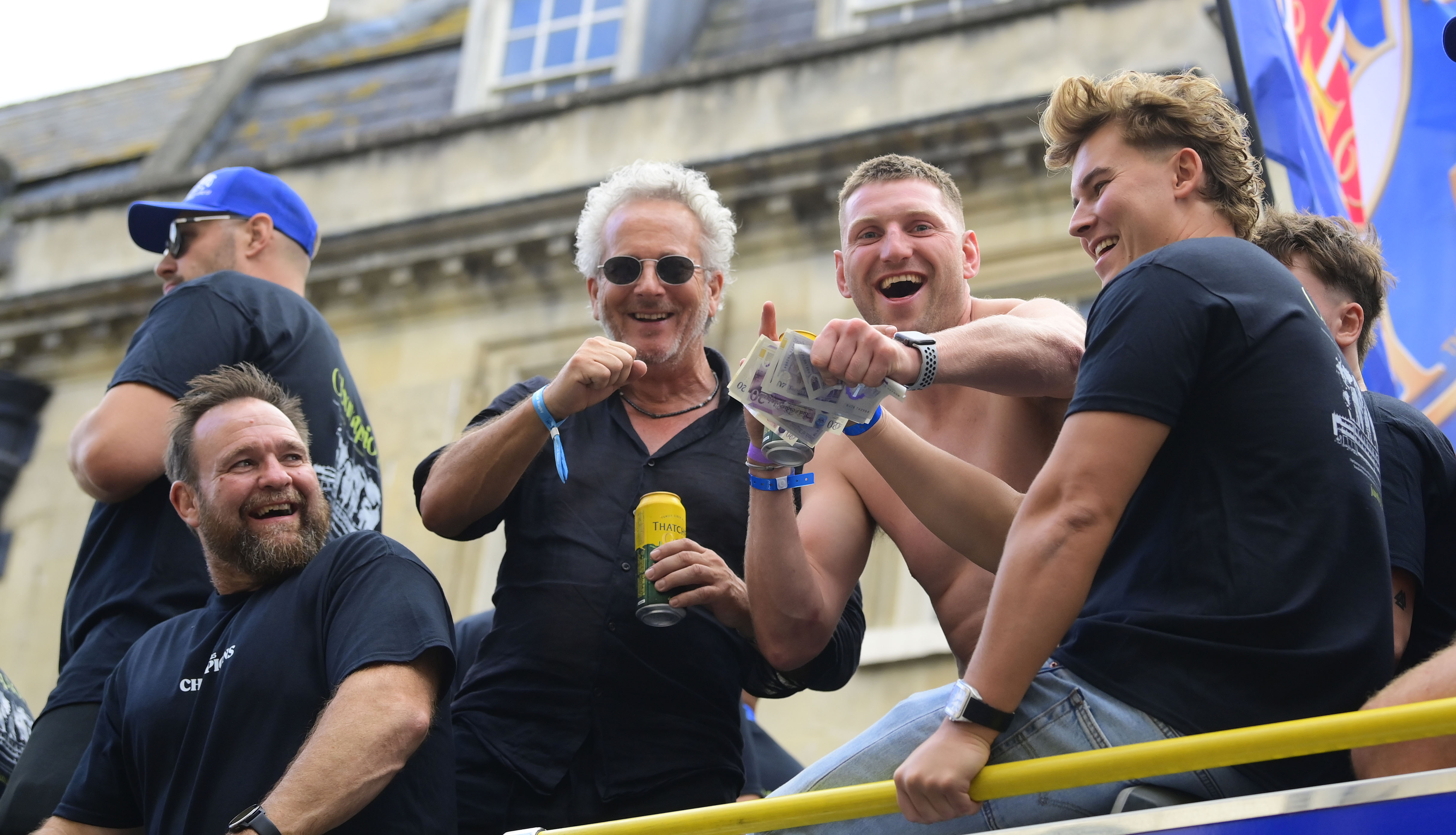 Bath Rugby owner Bruce Craig and players celebrating during a championship parade.