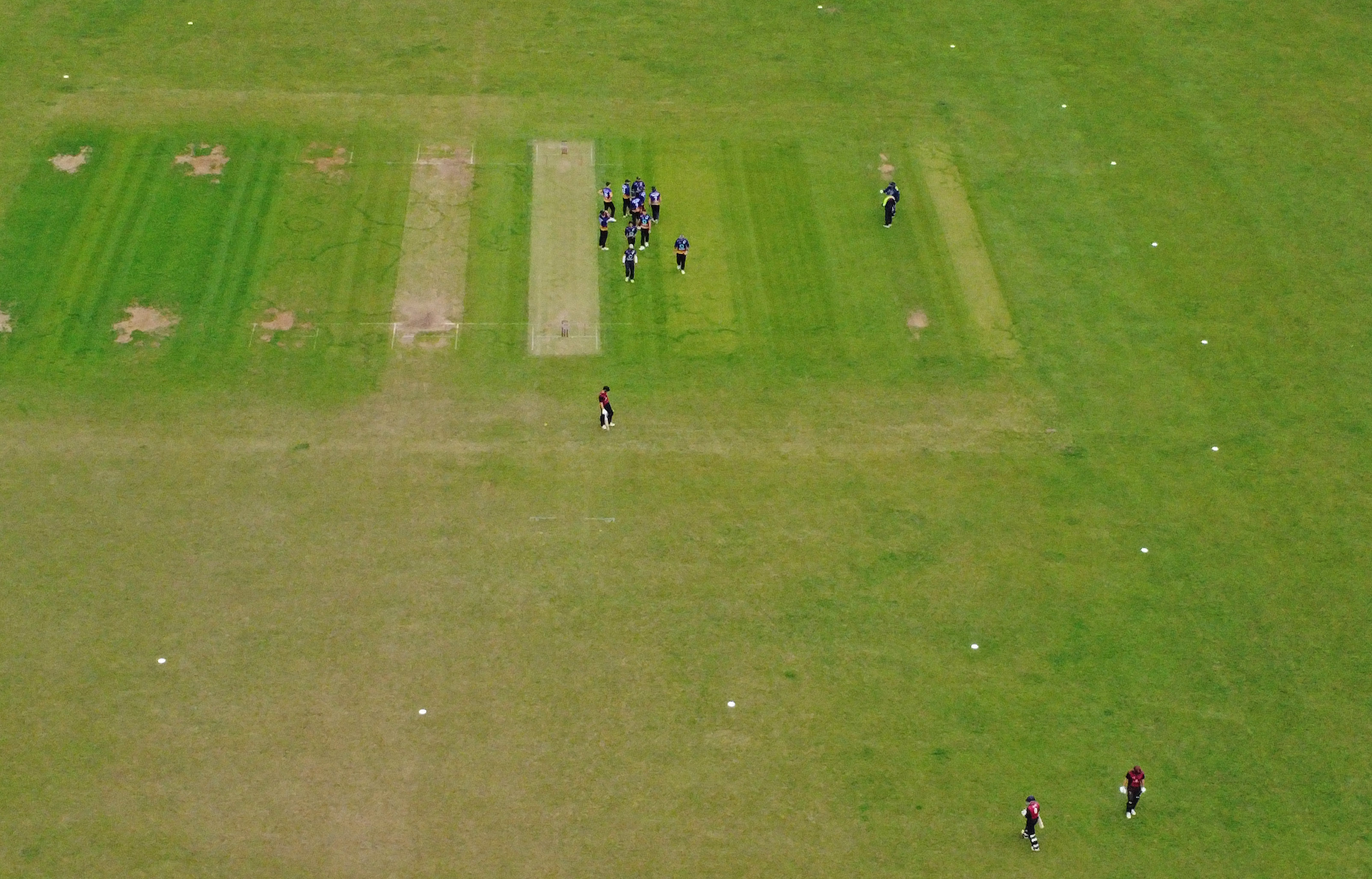 Aerial view of a cricket match in progress.