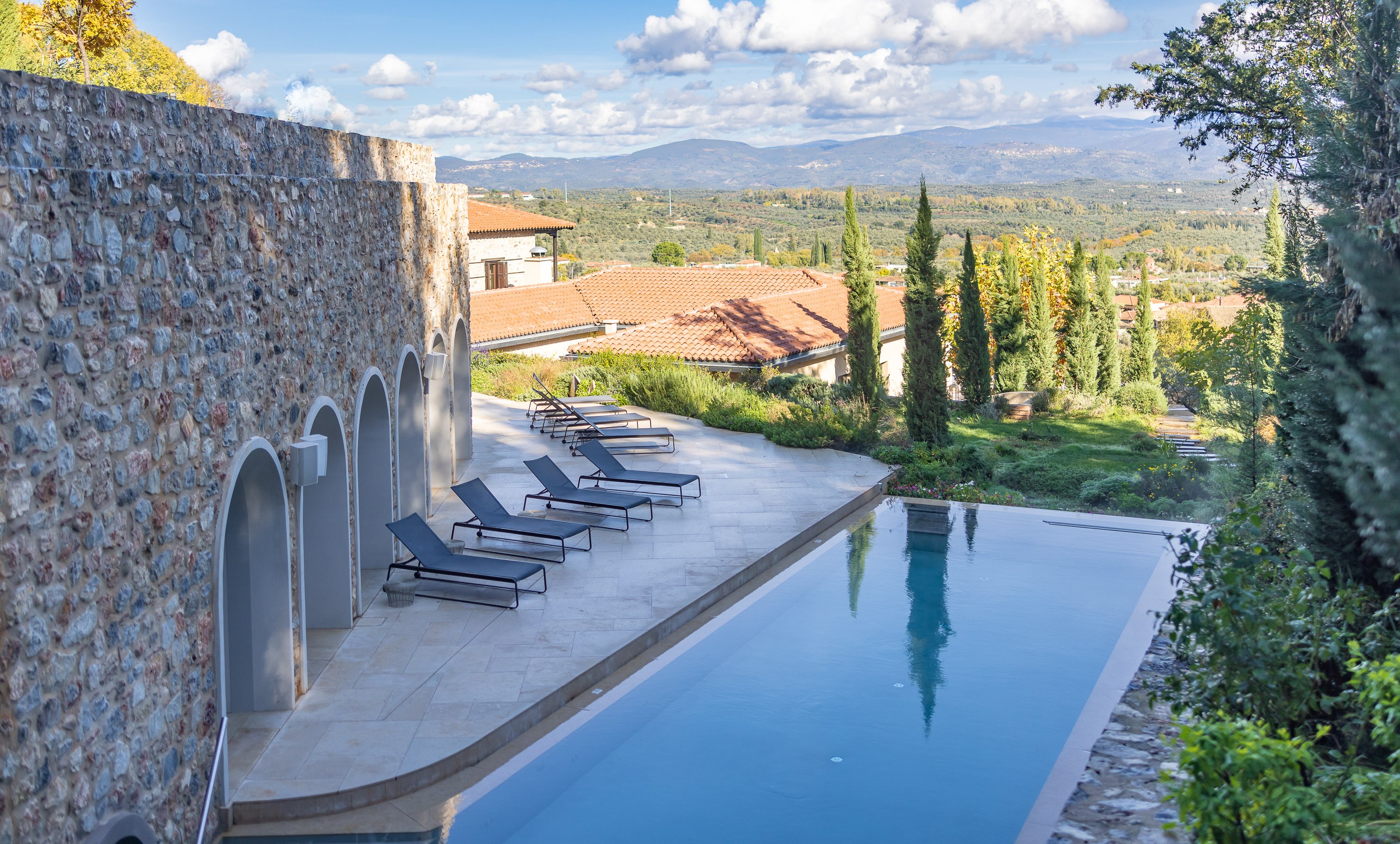 Euphoria Retreat, Sparta: infinity pool and lounge chairs overlooking a valley.