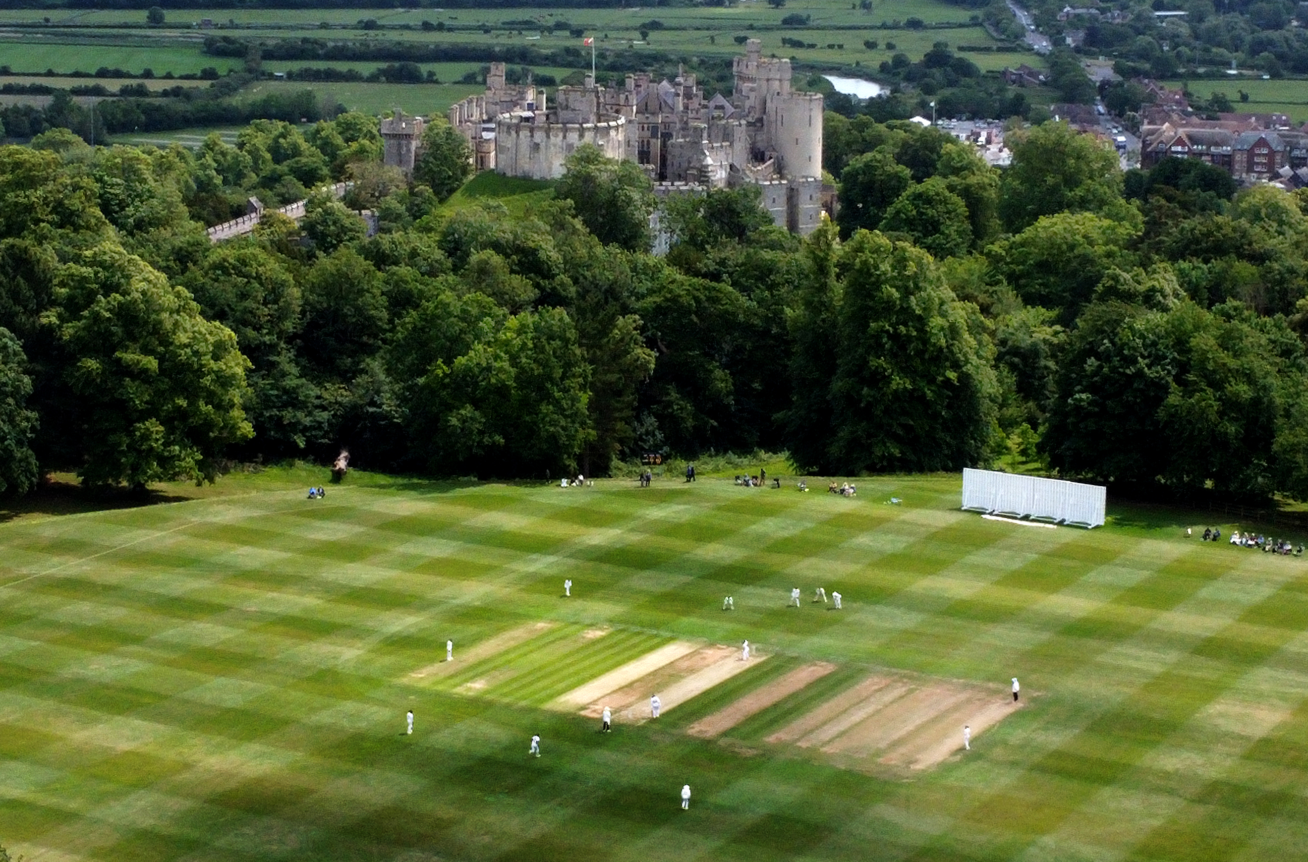 Aerial view of a cricket match in progress at Arundel Castle.