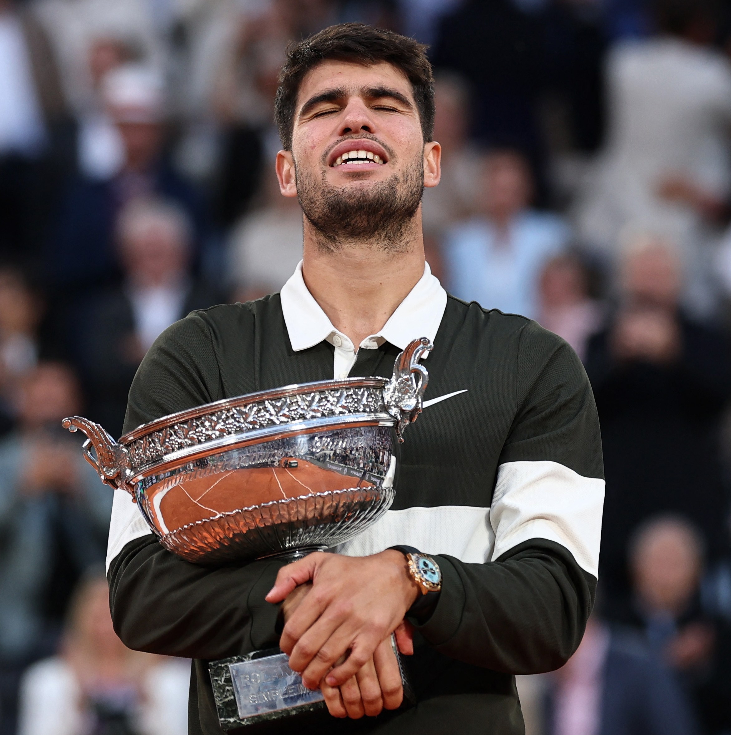 Carlos Alcaraz holding the French Open trophy.