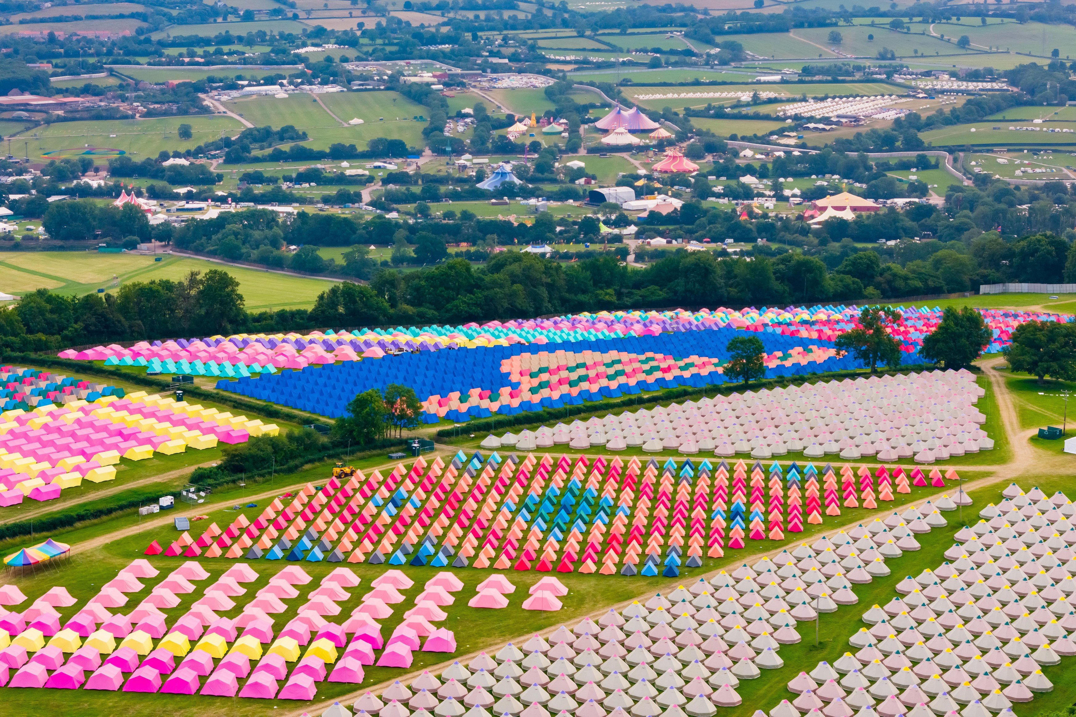 Aerial view of colorful tents at Glastonbury Festival campsite.